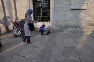 Cat and kid in front of Mosque